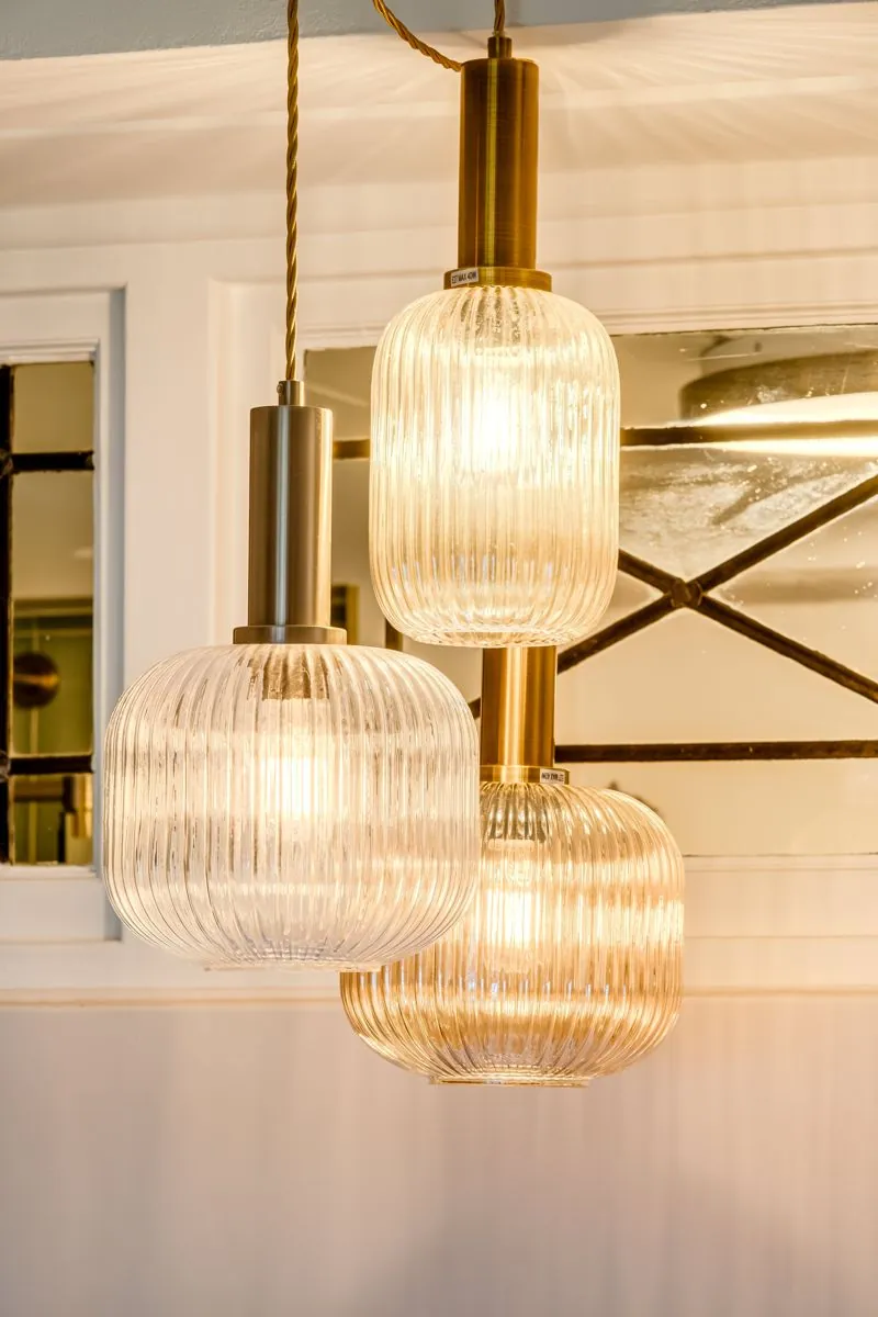 Ribbed glass pendant lamps over the dining table